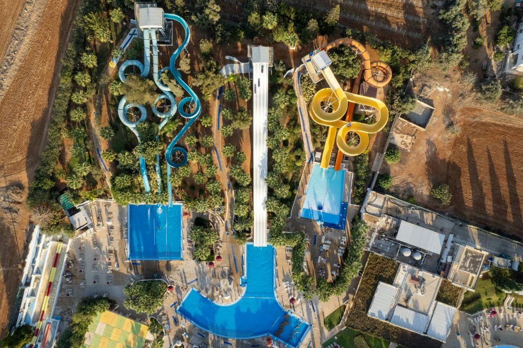 Explore the vibrant slides and pools of a water park in Ayia Napa, Cyprus, from above.
